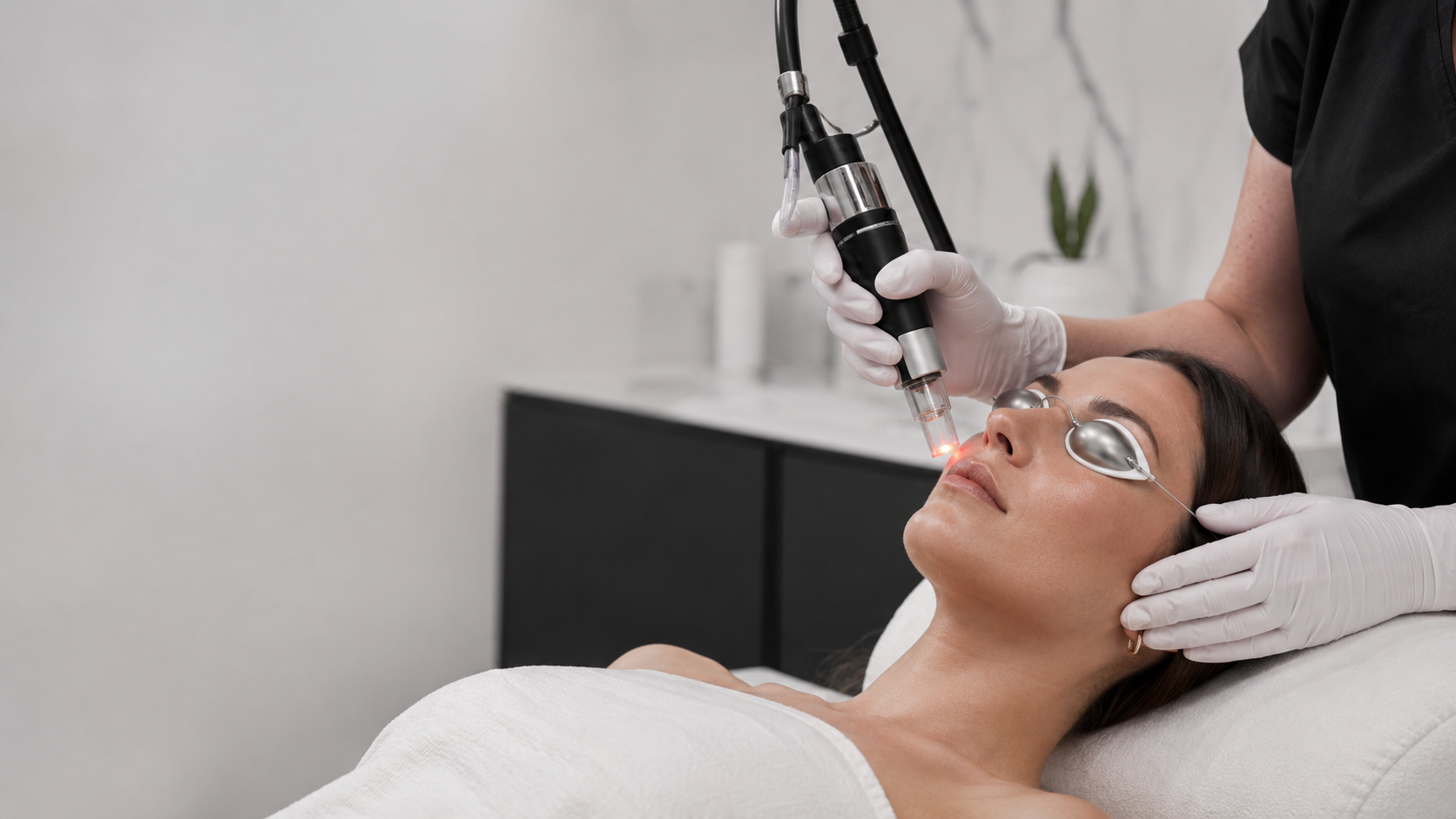 Laser skin treatment with patient wearing protective eye shields